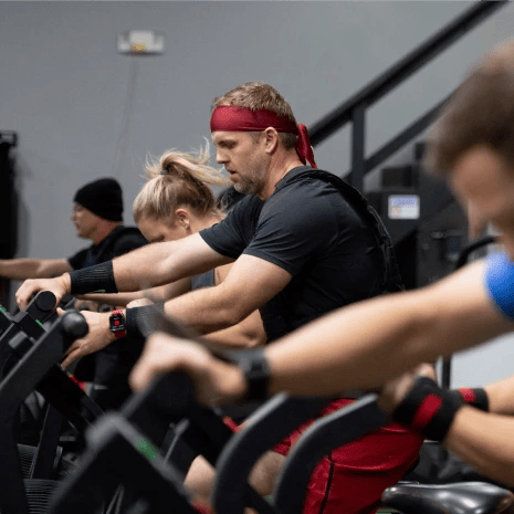 Group of people riding a bike in the gym